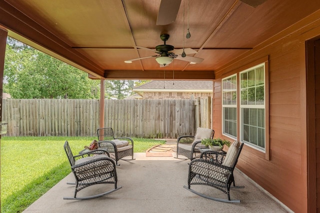 5720 Sunbird Ln, Beaumont, TX 77708 - fenced backyard with a ceiling fan, a patio area, and outdoor lounge area