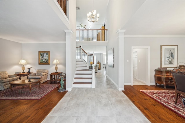 3003 Cedar Ridge Trl, Friendswood, TX 77546 - entrance foyer featuring stairway, decorative columns, a chandelier, crown molding, and a high ceiling