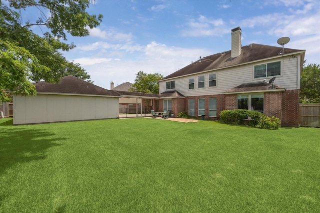3003 Cedar Ridge Trl, Friendswood, TX 77546 - back of house featuring a patio area, brick siding, and a chimney