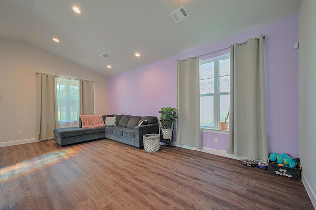 6418 Gresham St, Wallis, TX 77485 - living room featuring healthy amount of natural light, wood finished floors, lofted ceiling, and recessed lighting
