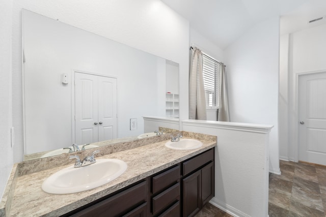 10750 Nathaniel Valley Path, Houston, TX 77016 - bathroom with double vanity and lofted ceiling