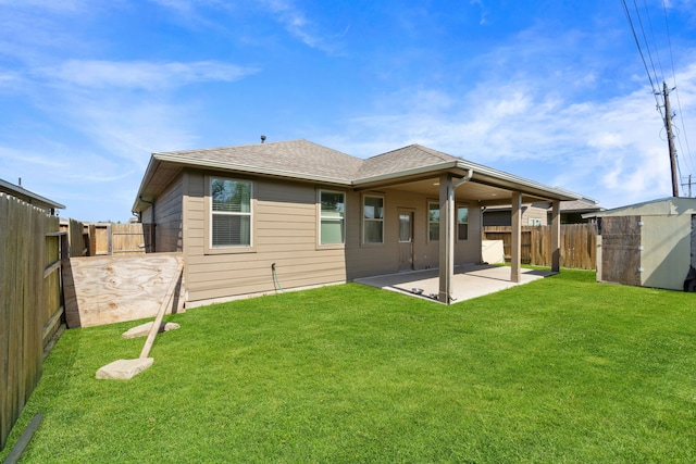 10750 Nathaniel Valley Path, Houston, TX 77016 - back of house with a patio area, a fenced backyard, roof with shingles, and a storage shed