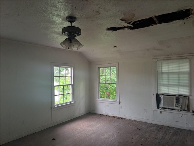 8343 Bonner, Houston, TX 77017 - unfurnished room with wood-type flooring, vaulted ceiling, a ceiling fan, and a textured ceiling