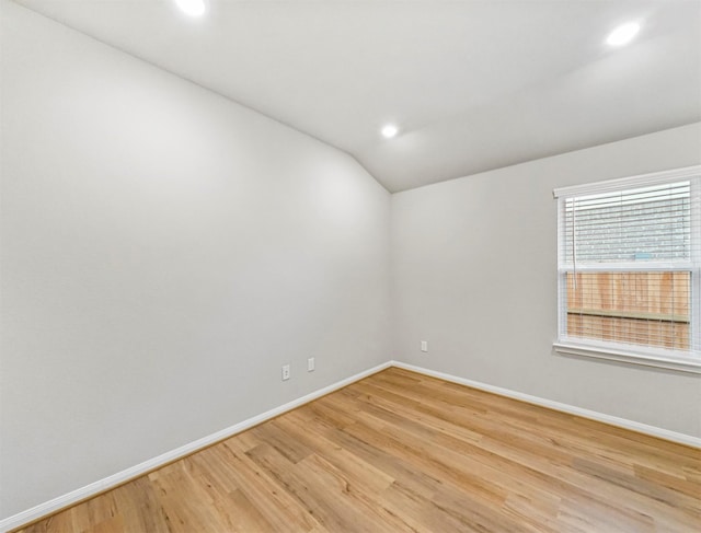 21622 Teton Rock Trl, Richmond, TX 77407 - spare room with lofted ceiling, recessed lighting, and light wood-style floors