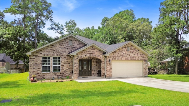 224 Evergreen Dr, Huntsville, TX 77340 - view of front of house with brick siding, a garage, a front lawn, and driveway
