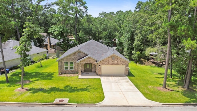 224 Evergreen Dr, Huntsville, TX 77340 - view of front facade with brick siding, driveway, a garage, and a front yard