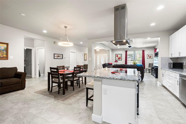 224 Evergreen Dr, Huntsville, TX 77340 - kitchen featuring open floor plan, island range hood, a center island, recessed lighting, and white cabinets