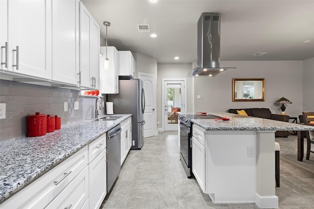 224 Evergreen Dr, Huntsville, TX 77340 - kitchen featuring island range hood, appliances with stainless steel finishes, a center island, tasteful backsplash, and a kitchen bar