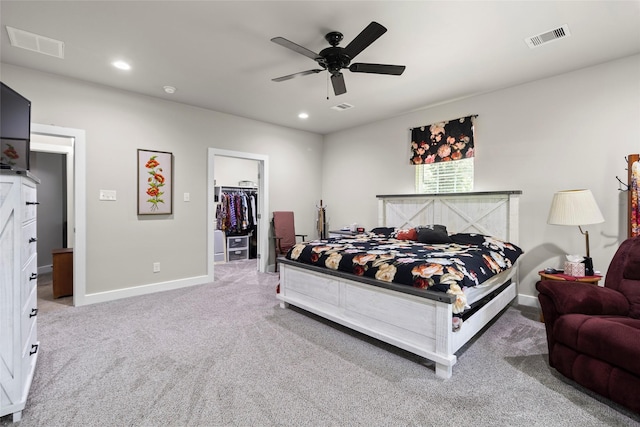 224 Evergreen Dr, Huntsville, TX 77340 - carpeted bedroom with a walk in closet, a ceiling fan, and recessed lighting