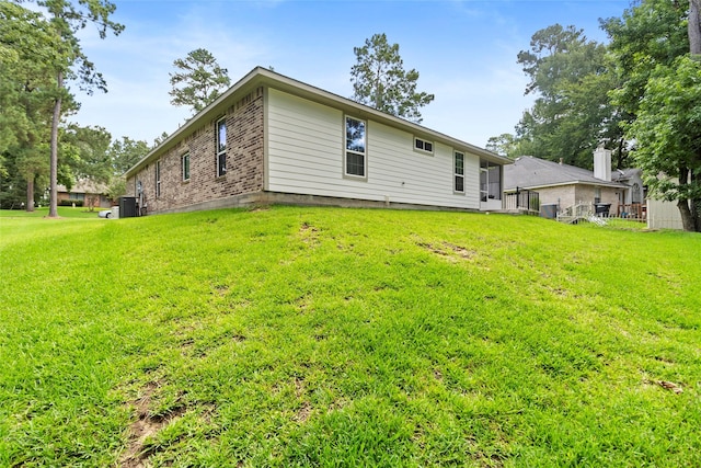 224 Evergreen Dr, Huntsville, TX 77340 - rear view of property with a yard and brick siding