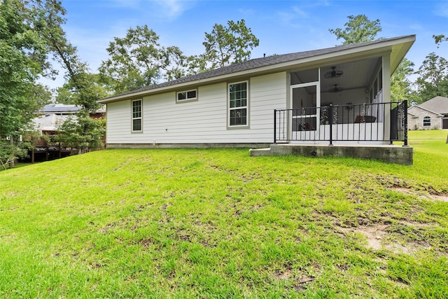 224 Evergreen Dr, Huntsville, TX 77340 - rear view of house with a lawn and a sunroom