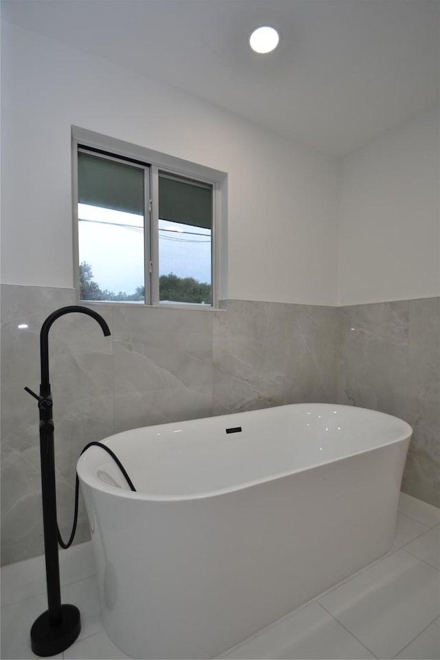 5330 Dumfries Dr, Houston, TX 77096 - full bath featuring tile walls, a freestanding tub, and wainscoting
