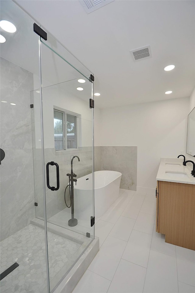 5330 Dumfries Dr, Houston, TX 77096 - full bath featuring a soaking tub, a shower stall, tile patterned flooring, double vanity, and recessed lighting