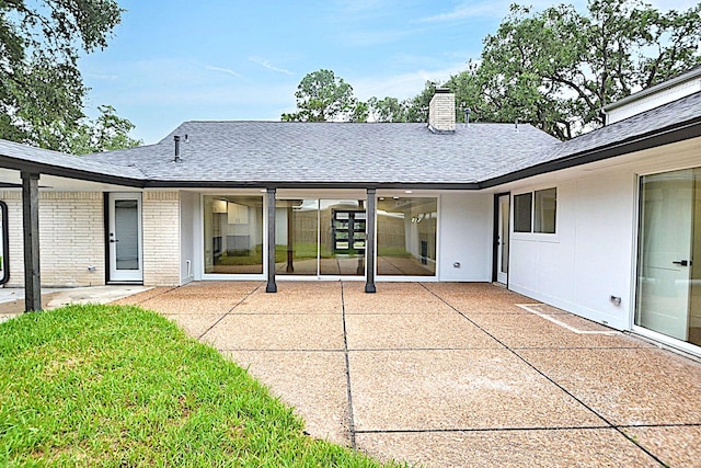5330 Dumfries Dr, Houston, TX 77096 - back of house with roof with shingles, a chimney, a patio area, and a yard