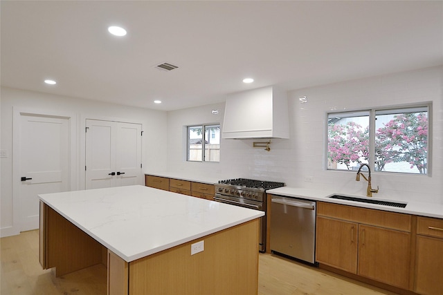 5330 Dumfries Dr, Houston, TX 77096 - kitchen with appliances with stainless steel finishes, light wood-type flooring, premium range hood, backsplash, and recessed lighting