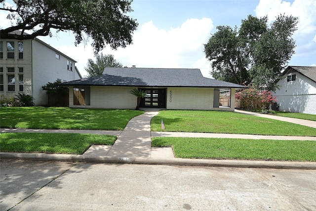 5330 Dumfries Dr, Houston, TX 77096 - mid-century inspired home featuring a front lawn and roof with shingles
