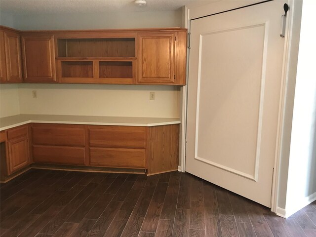 1311 Antoine Dr Unit 159, Houston, TX 77055 - kitchen with dark wood-style flooring, brown cabinetry, open shelves, and light countertops