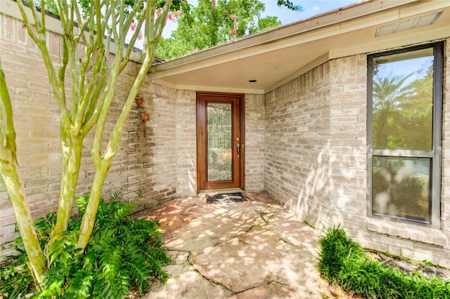 3831 Wood Stone Walk Dr, Houston, TX 77084 - view of exterior entry with brick siding and a patio