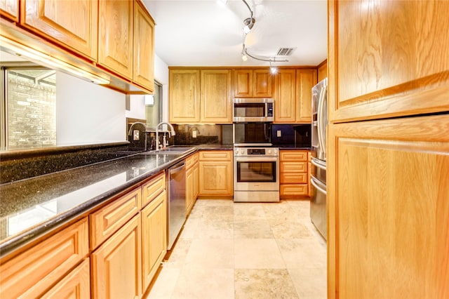 3831 Wood Stone Walk Dr, Houston, TX 77084 - kitchen with appliances with stainless steel finishes and track lighting