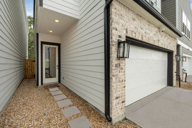 413 Stonework Oaks Ln, Houston, TX 77076 - view of exterior entry with brick siding and an attached garage