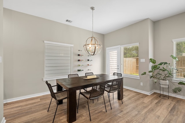 413 Stonework Oaks Ln, Houston, TX 77076 - dining area featuring light wood-style flooring and a chandelier
