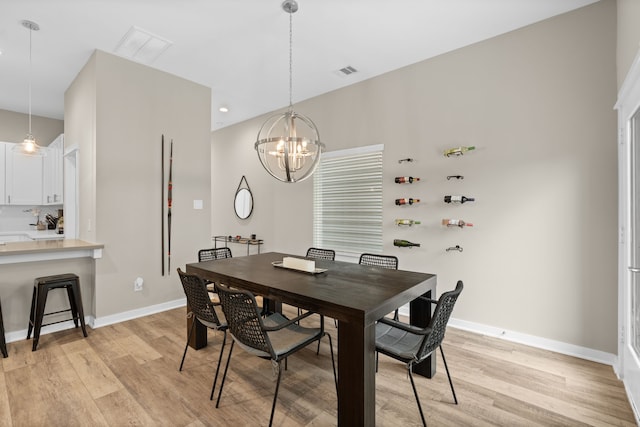 413 Stonework Oaks Ln, Houston, TX 77076 - dining area with light wood finished floors and a chandelier