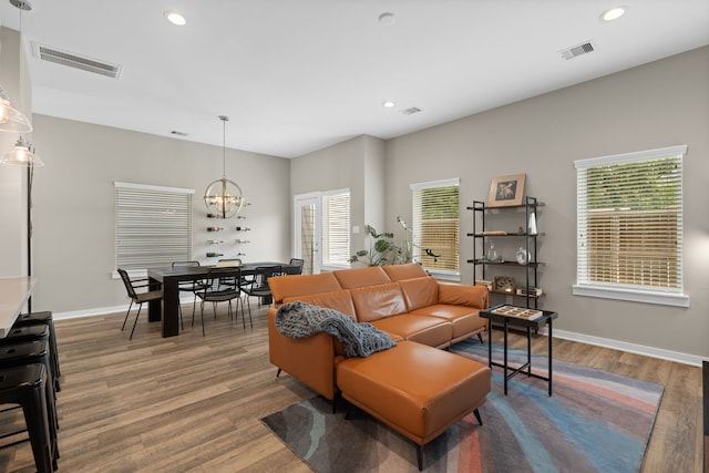 413 Stonework Oaks Ln, Houston, TX 77076 - living area with wood finished floors, a chandelier, and recessed lighting