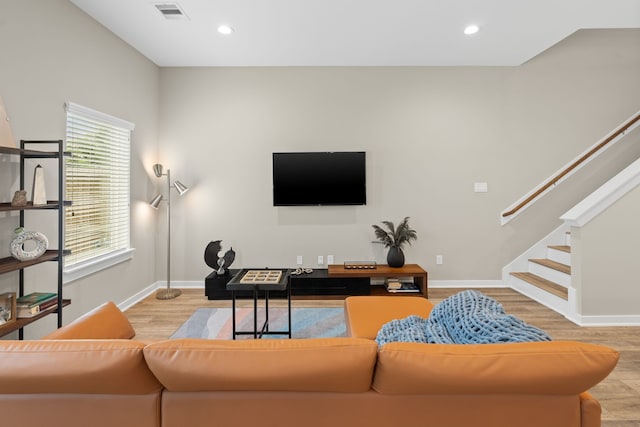 413 Stonework Oaks Ln, Houston, TX 77076 - living area with wood finished floors, stairs, and recessed lighting