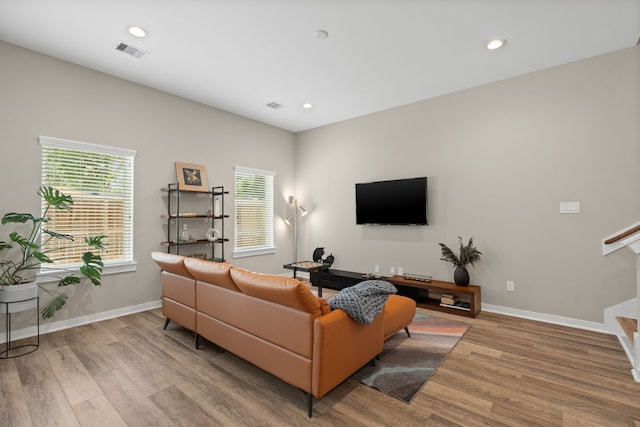413 Stonework Oaks Ln, Houston, TX 77076 - living room with wood finished floors, recessed lighting, and stairway