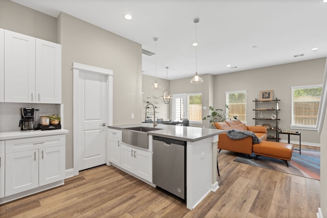 413 Stonework Oaks Ln, Houston, TX 77076 - kitchen featuring stainless steel dishwasher, a peninsula, light wood-style flooring, white cabinets, and recessed lighting