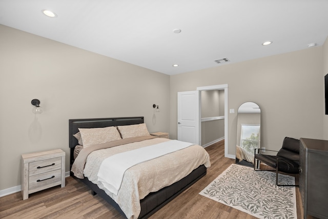 413 Stonework Oaks Ln, Houston, TX 77076 - bedroom featuring wood finished floors and recessed lighting