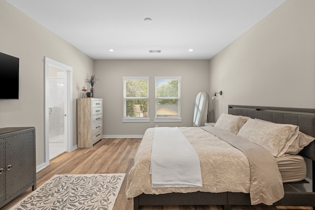 413 Stonework Oaks Ln, Houston, TX 77076 - bedroom featuring light wood finished floors, recessed lighting, and connected bathroom