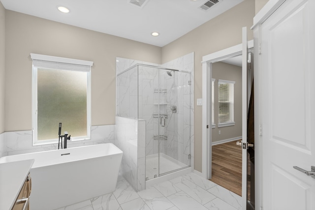 413 Stonework Oaks Ln, Houston, TX 77076 - full bath with a soaking tub, a marble finish shower, recessed lighting, and marble finish flooring