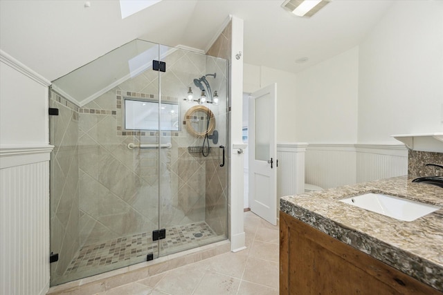 208 E 12th St, Houston, TX 77008 - full bathroom with vanity, a stall shower, tile patterned floors, wainscoting, and lofted ceiling