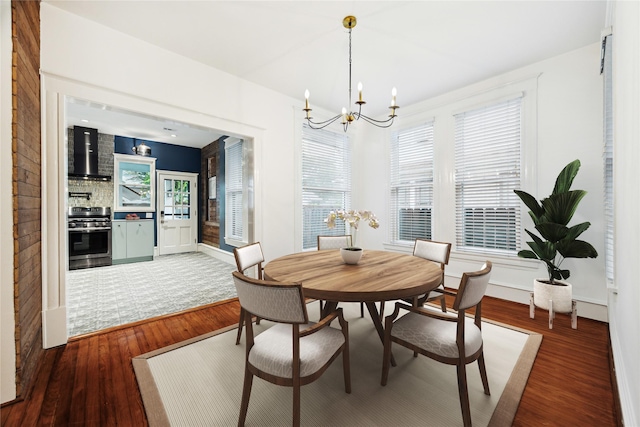 208 E 12th St, Houston, TX 77008 - dining space featuring a chandelier and wood finished floors