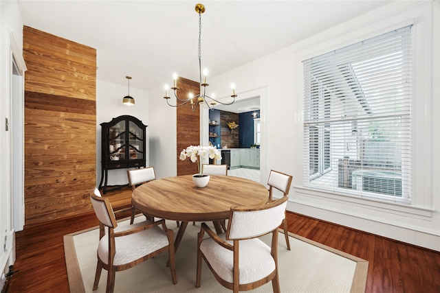 208 E 12th St, Houston, TX 77008 - dining room with a chandelier, wood finished floors, and wood walls