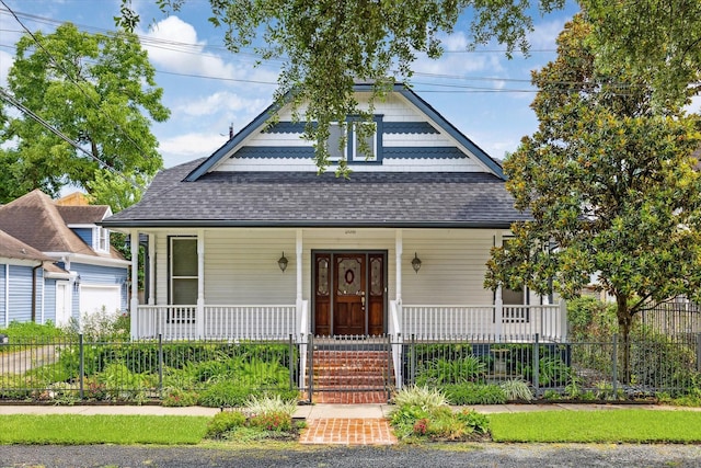 208 E 12th St, Houston, TX 77008 - view of front of home with a porch, a shingled roof, and a garage