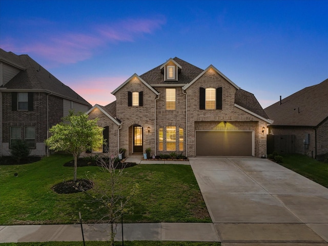 706 Westwood Dr, League City, TX 77573 - french country inspired facade with brick siding, concrete driveway, a front yard, and a garage