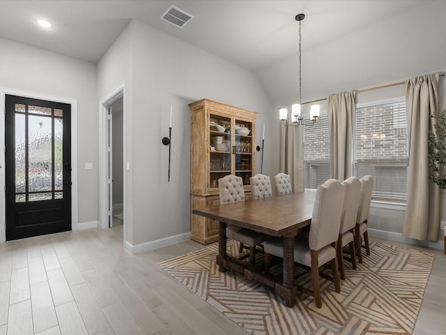 706 Westwood Dr, League City, TX 77573 - dining space featuring a chandelier, light wood-style floors, and lofted ceiling