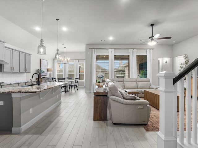 706 Westwood Dr, League City, TX 77573 - living area featuring light wood-style flooring, a ceiling fan, recessed lighting, and a chandelier