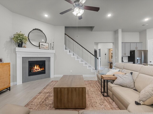 706 Westwood Dr, League City, TX 77573 - living area featuring ceiling fan, a fireplace, stairs, light wood-style flooring, and recessed lighting