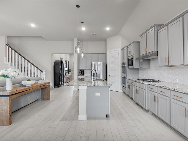 706 Westwood Dr, League City, TX 77573 - kitchen featuring gray cabinetry, stainless steel appliances, tasteful backsplash, light stone countertops, and recessed lighting