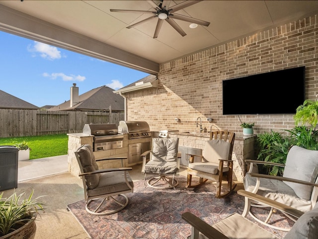 706 Westwood Dr, League City, TX 77573 - fenced backyard with exterior kitchen, ceiling fan, and a patio area