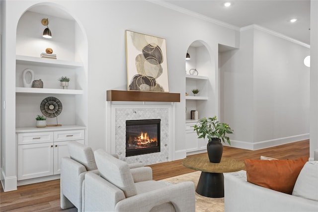 161 Pine Branch Dr, Montgomery, TX 77356 - living area featuring built in shelves, wood finished floors, ornamental molding, a fireplace, and recessed lighting