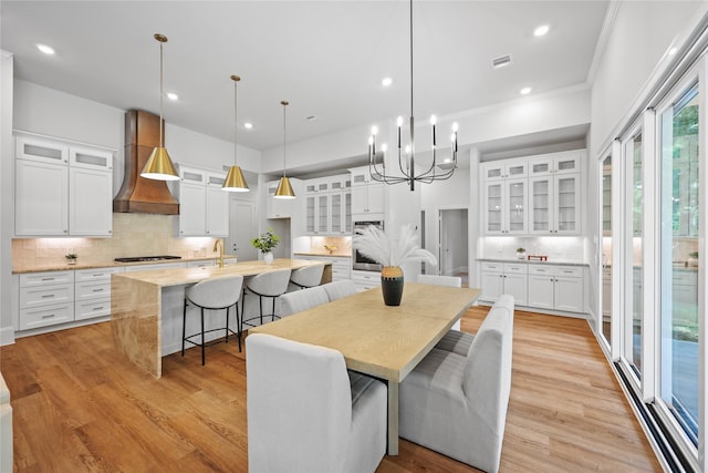 161 Pine Branch Dr, Montgomery, TX 77356 - dining room with light wood finished floors, a chandelier, recessed lighting, and ornamental molding