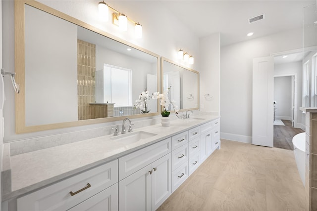 161 Pine Branch Dr, Montgomery, TX 77356 - bathroom with double vanity, a freestanding bath, and recessed lighting