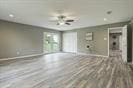 3889 County Road 155, Alvin, TX 77511 - unfurnished living room featuring ceiling fan and wood finished floors