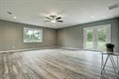 3889 County Road 155, Alvin, TX 77511 - unfurnished living room with baseboards and wood finished floors