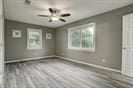 3889 County Road 155, Alvin, TX 77511 - unfurnished bedroom with baseboards and wood finished floors