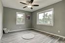 3889 County Road 155, Alvin, TX 77511 - unfurnished bedroom featuring baseboards and wood finished floors